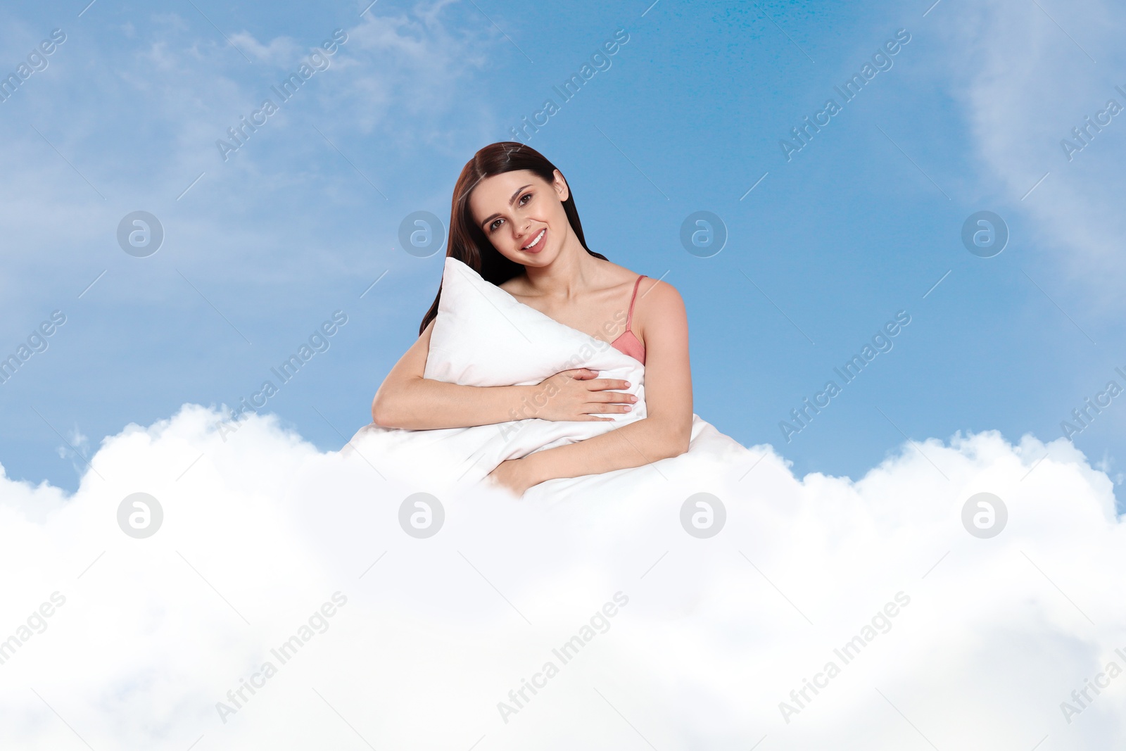 Young woman with pillow sitting on fluffy cloud in blue sky. Bedtime Image of Young woman with pillow sitting on fluffy cloud in blue sky. Bedtime