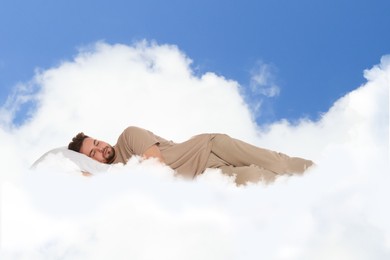 Image of Man sleeping on fluffy cloud in blue sky. Bedtime