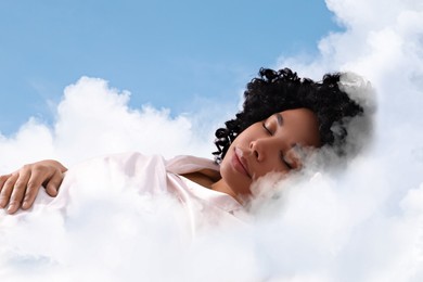 Image of Woman sleeping on fluffy cloud in blue sky. Bedtime