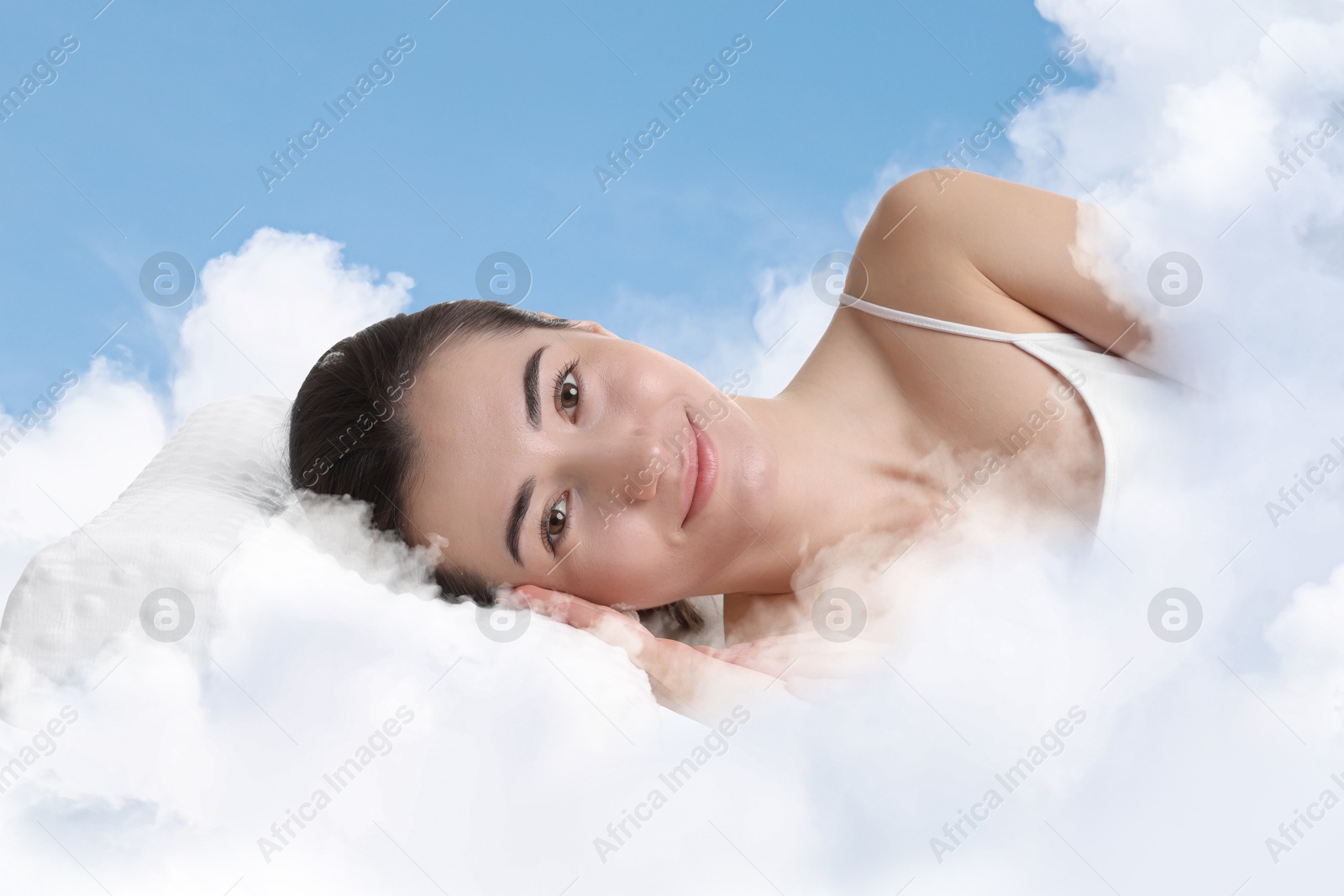 Woman lying on fluffy cloud in blue sky. Bedtime Image of Woman lying on fluffy cloud in blue sky. Bedtime