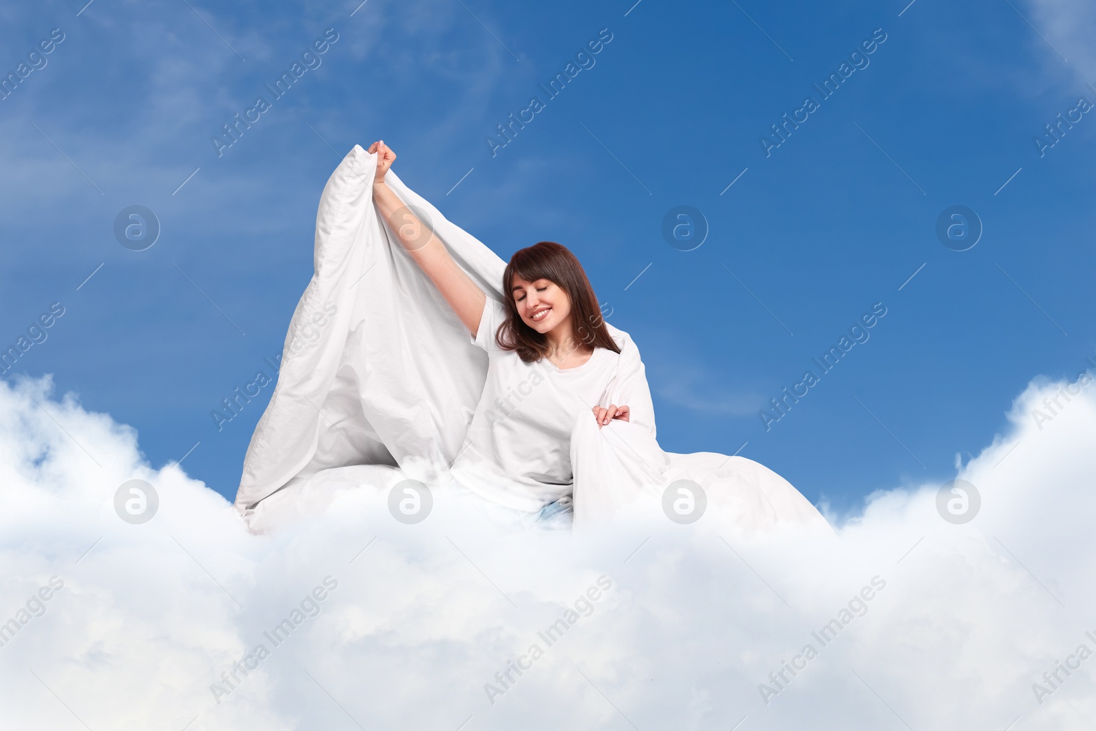Happy woman with blanket on fluffy cloud in blue sky. Bedtime Image of Happy woman with blanket on fluffy cloud in blue sky. Bedtime
