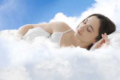 Image of Woman sleeping on fluffy cloud in blue sky. Bedtime