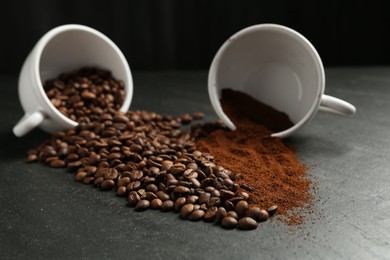 Photo of Aromatic ground coffee and beans on black table, closeup