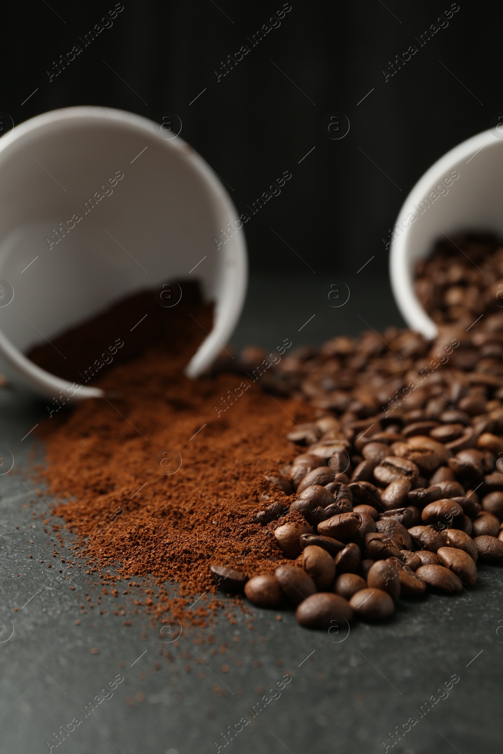 Aromatic ground coffee and beans on black table, closeup Photo of Aromatic ground coffee and beans on black table, closeup