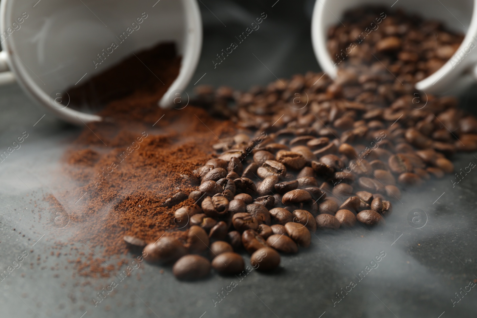 Aromatic ground coffee and beans on black table, closeup Photo of Aromatic ground coffee and beans on black table, closeup