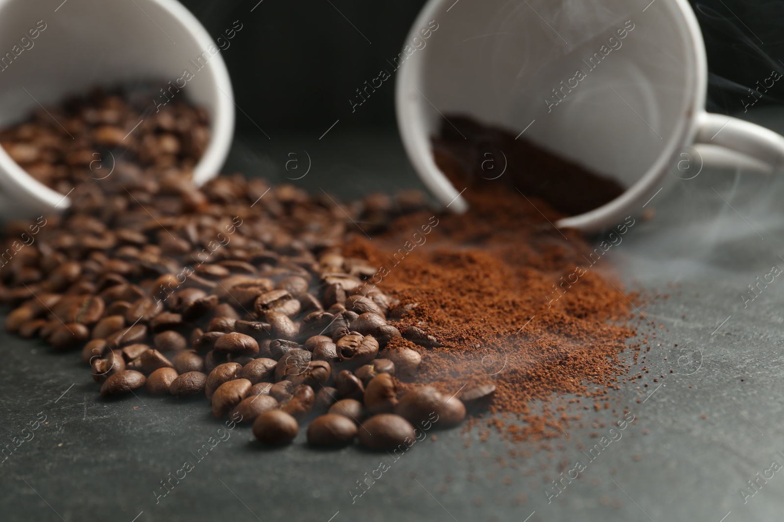 Aromatic ground coffee and beans on black table, closeup Photo of Aromatic ground coffee and beans on black table, closeup