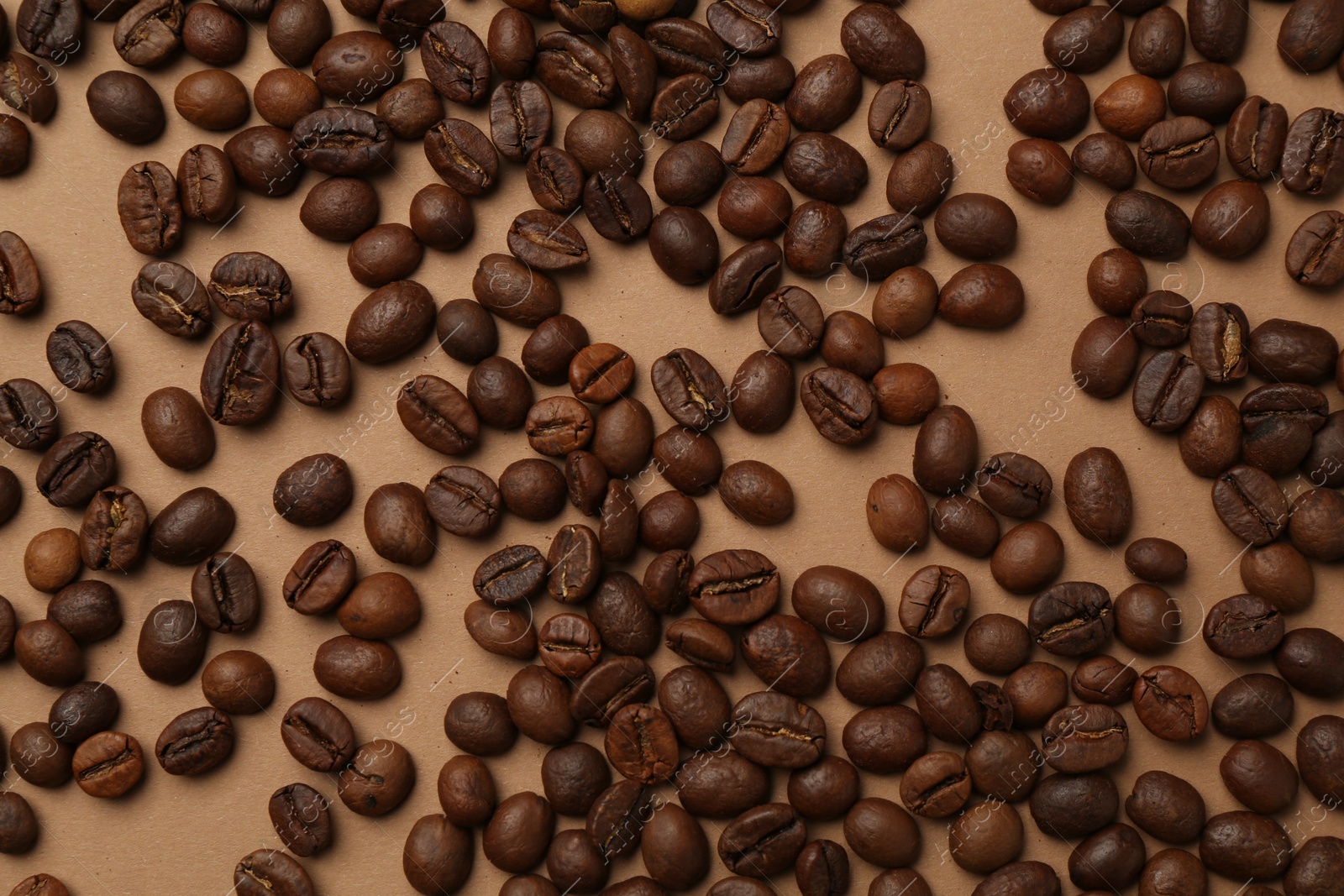 Aromatic coffee beans on beige background, flat lay Photo of Aromatic coffee beans on beige background, flat lay