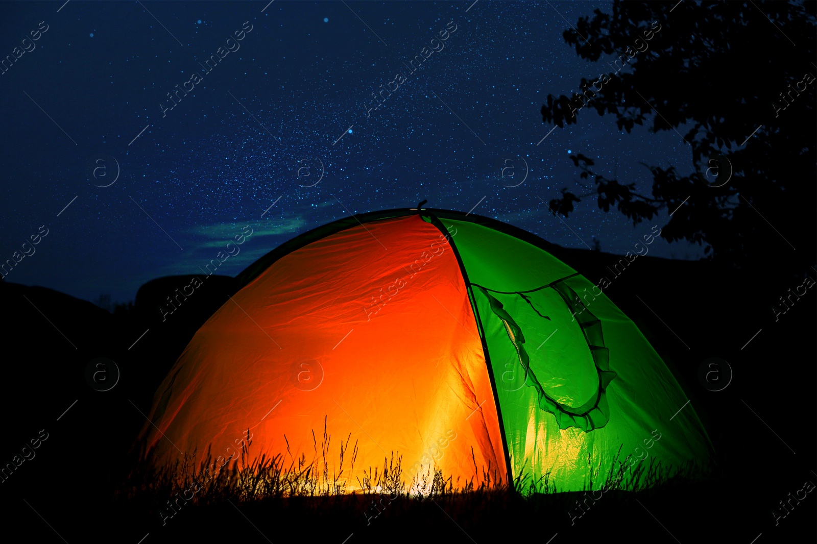 Tent lit from inside in wilderness at night. Camping season Image of Tent lit from inside in wilderness at night. Camping season