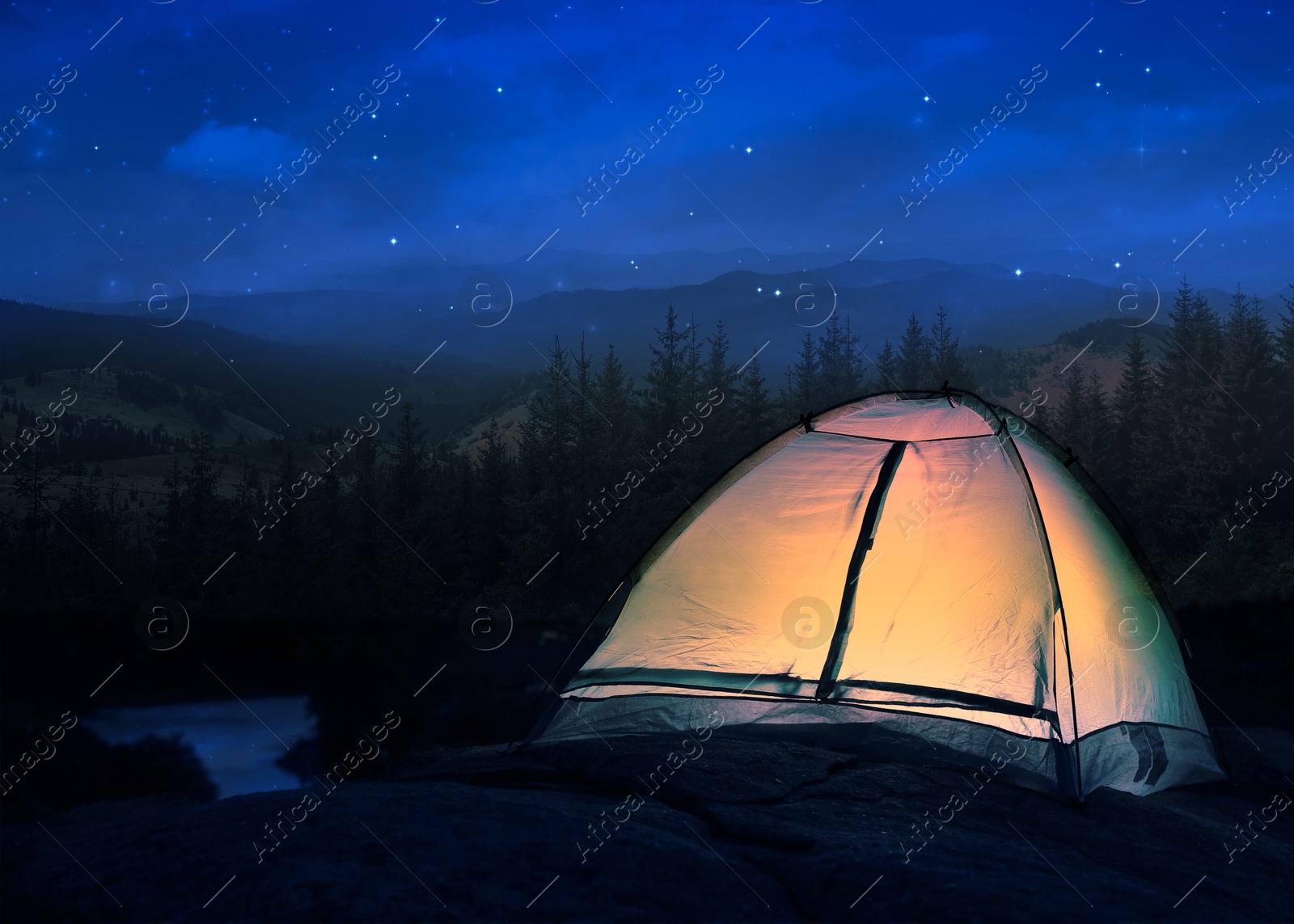 Camping tent lit from inside in mountains at night under starry sky Image of Camping tent lit from inside in mountains at night under starry sky