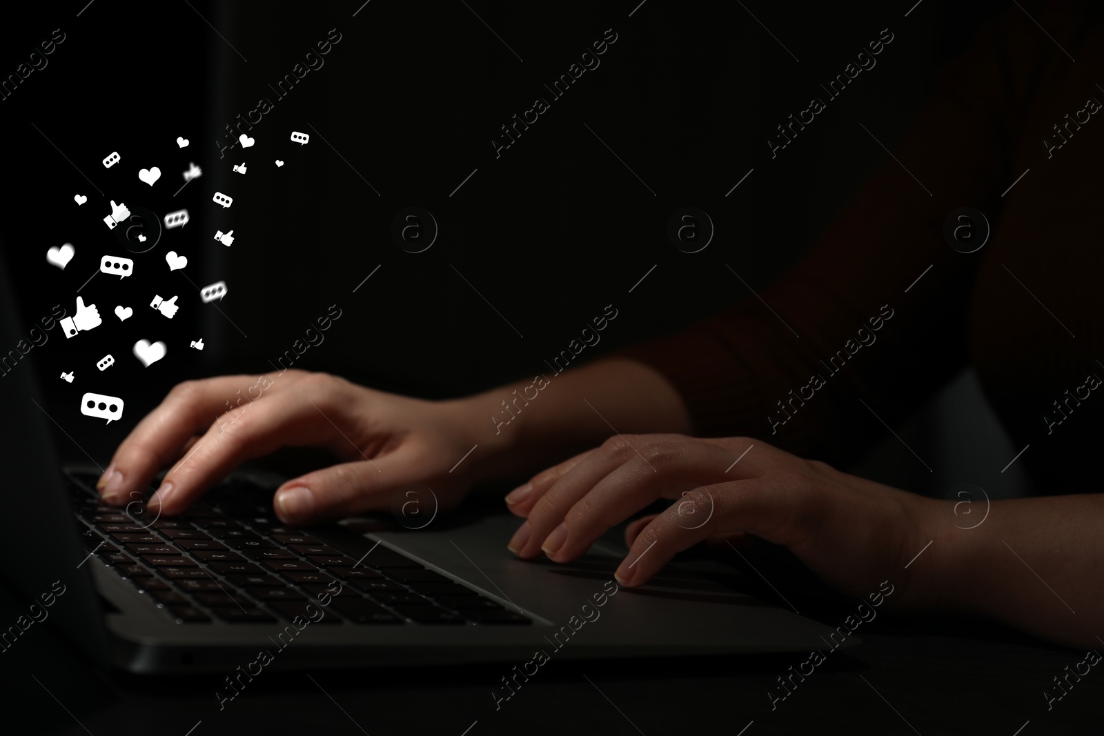 Woman using laptop at night, closeup. Social media notifications (messages and likes) flying out of computer Image of Woman using laptop at night, closeup. Social media notifications (messages and likes) flying out of computer