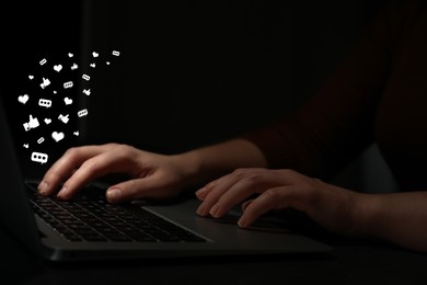 Image of Woman using laptop at night, closeup. Social media notifications (messages and likes) flying out of computer