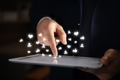 Image of Man using tablet computer, closeup. Social media notifications flying out of device