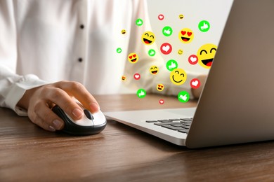 Image of Woman using laptop at table, closeup. Social media notifications (likes and emojis) flying out of computer