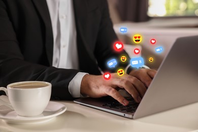 Image of Man using laptop at table, closeup. Social media notifications (likes, messages and emojis) flying out of computer