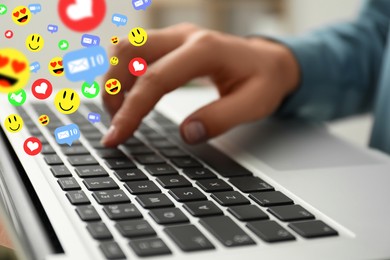 Image of Woman using laptop at table, closeup. Social media notifications (likes, messages and emojis) flying out of computer