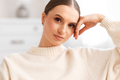 Photo of Portrait of beautiful young woman at home