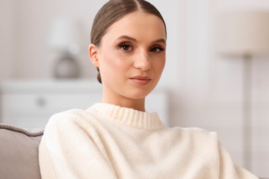 Photo of Portrait of beautiful young woman at home