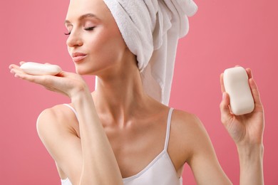 Photo of Beautiful woman with soap bars on pink background