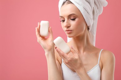 Photo of Beautiful woman with soap bars on pink background. Space for text