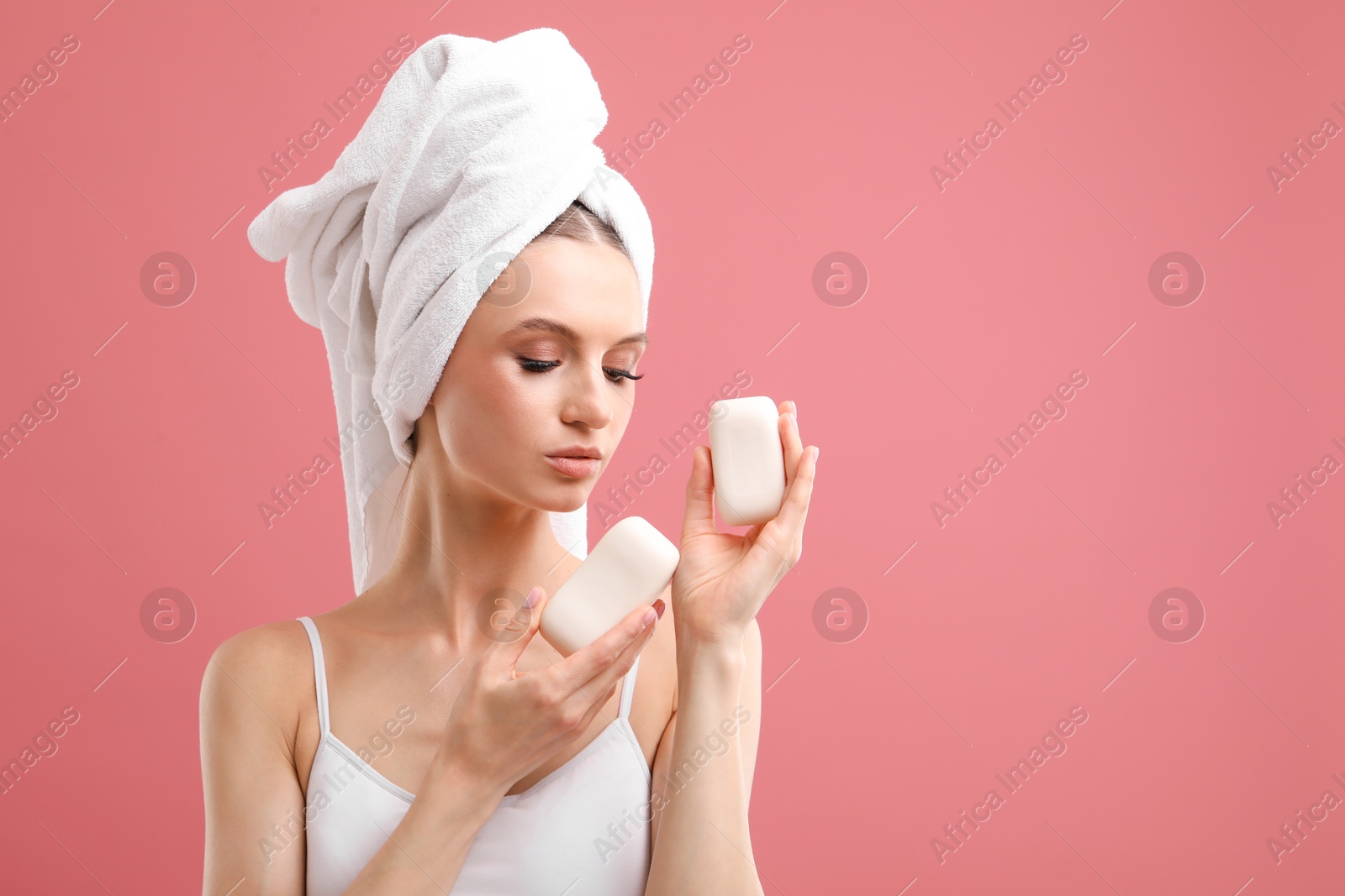 Beautiful woman with soap bars on pink background. Space for text Photo of Beautiful woman with soap bars on pink background. Space for text