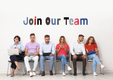 Image of Join Our Team. Group of young people waiting for job interview near light wall. Recruitment, human resource concept