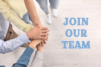 Image of Join Our Team. Group of employees joining hands in office, top view. Recruitment, human resource concept