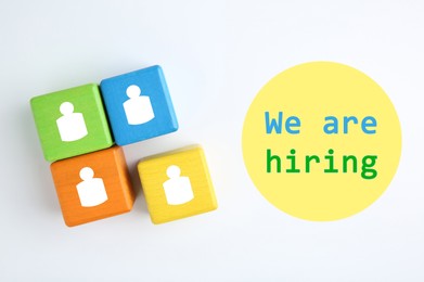 Image of We Are Hiring. Colorful cubes with human icons on white background, top view. Recruitment, human resource concept