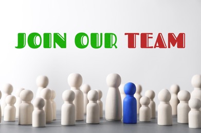 Image of Join Our Team. Blue figure among wooden ones on light background. Recruitment, human resource concept