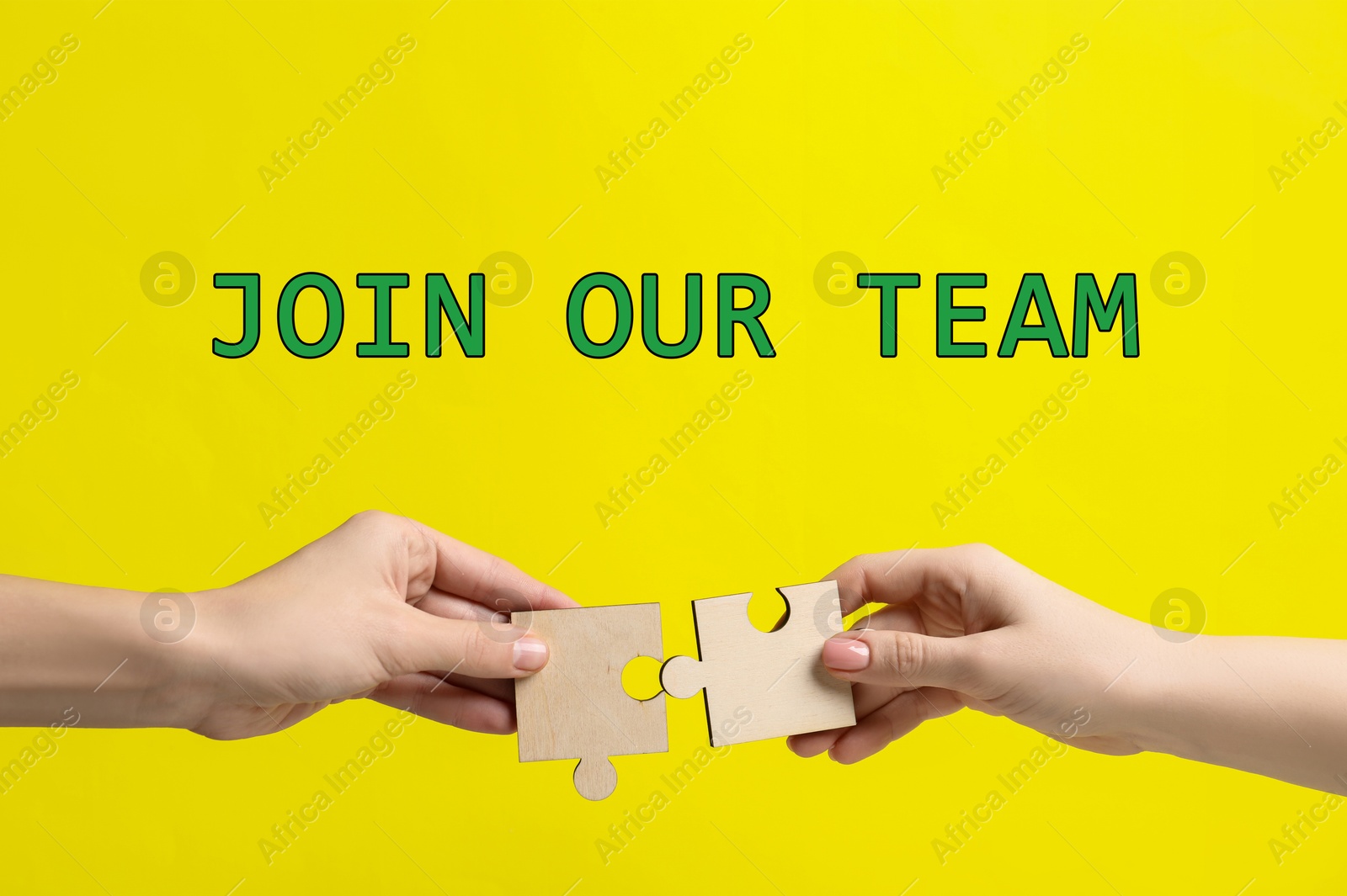 Join Our Team. Partners putting puzzle pieces together on yellow background, closeup. Recruitment, human resource concept Image of Join Our Team. Partners putting puzzle pieces together on yellow background, closeup. Recruitment, human resource concept
