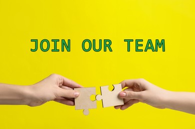 Image of Join Our Team. Partners putting puzzle pieces together on yellow background, closeup. Recruitment, human resource concept