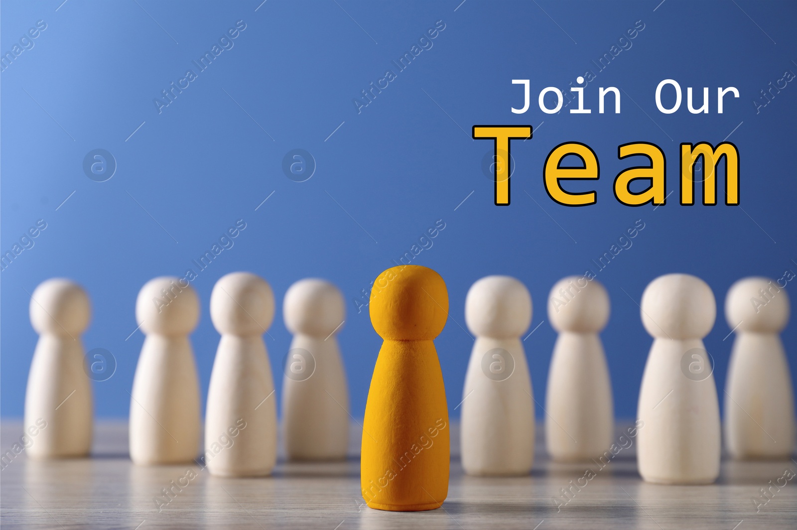Join Our Team. Orange human figure in front of wooden ones against blue background. Recruitment, human resource concept Image of Join Our Team. Orange human figure in front of wooden ones against blue background. Recruitment, human resource concept