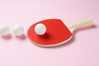Photo of Ping pong racket and balls on pink background