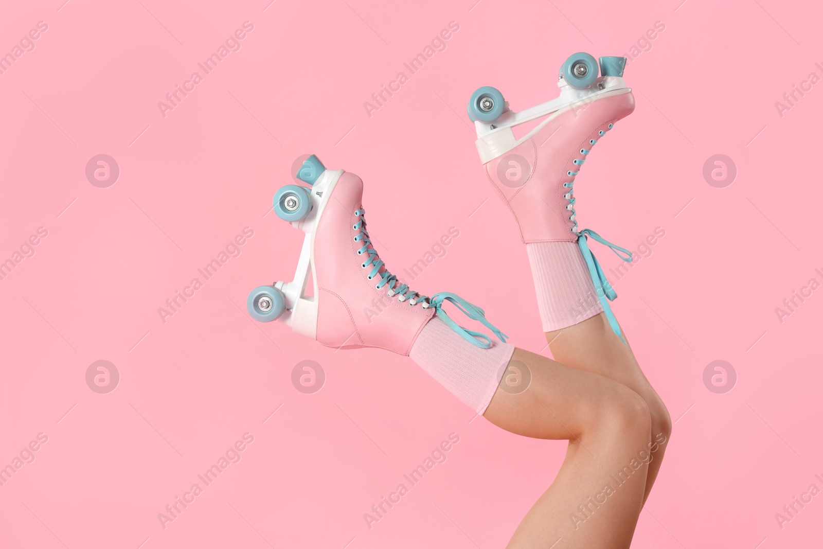 Woman in roller skates on pink background, closeup. Space for text Photo of Woman in roller skates on pink background, closeup. Space for text