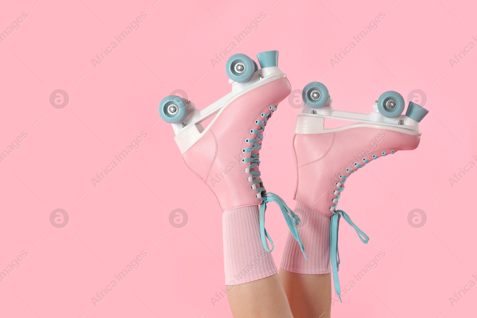 Woman in roller skates on pink background, closeup. Space for text Photo of Woman in roller skates on pink background, closeup. Space for text
