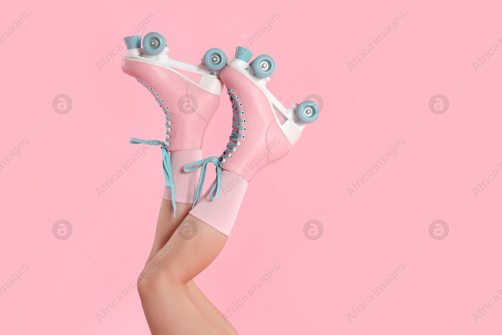 Woman in roller skates on pink background, closeup. Space for text Photo of Woman in roller skates on pink background, closeup. Space for text