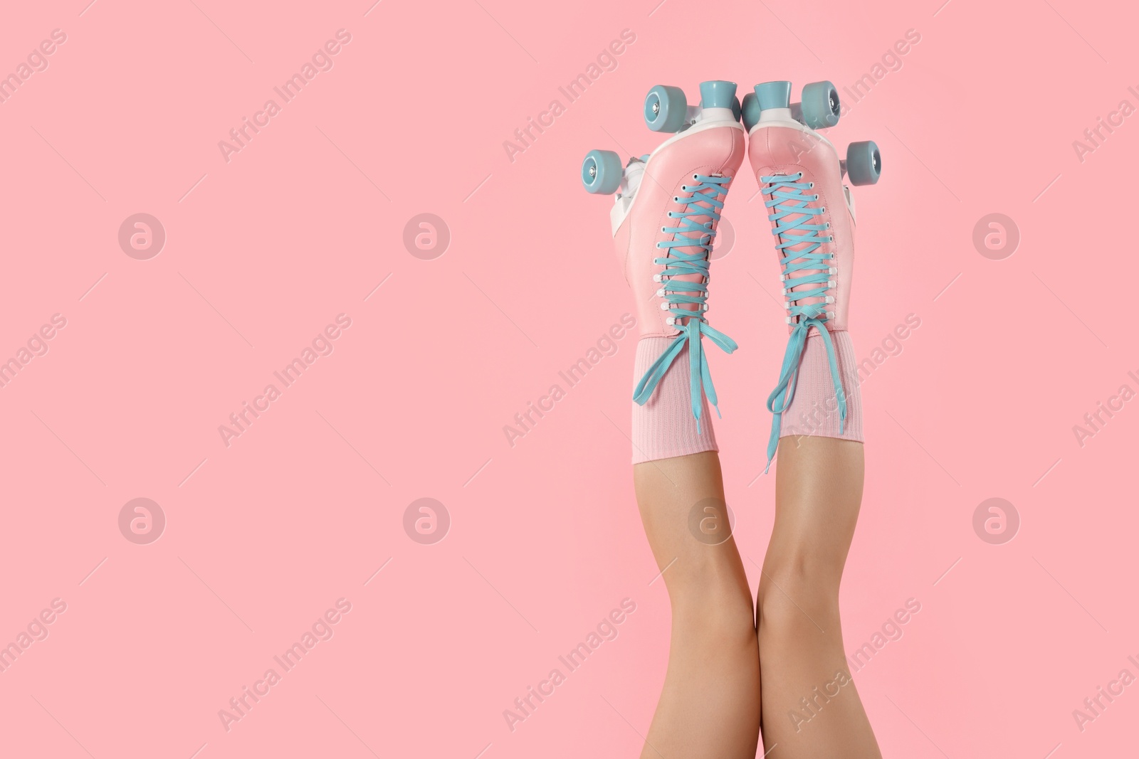 Woman in roller skates on pink background, closeup. Space for text Photo of Woman in roller skates on pink background, closeup. Space for text