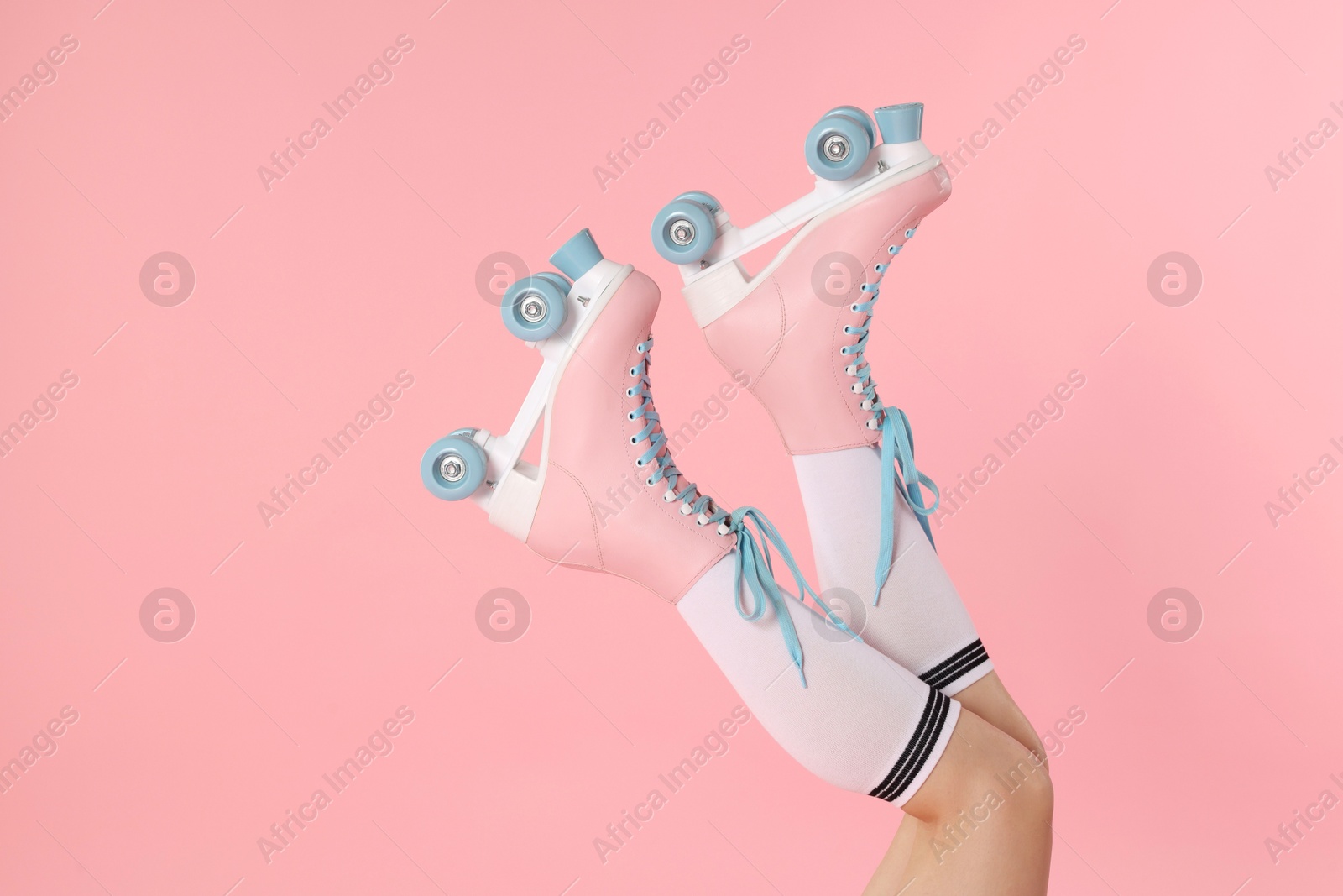 Woman in roller skates on pink background, closeup. Space for text Photo of Woman in roller skates on pink background, closeup. Space for text