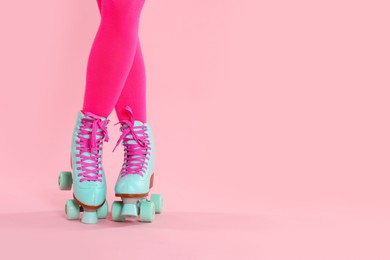 Photo of Woman in roller skates on pink background, closeup. Space for text