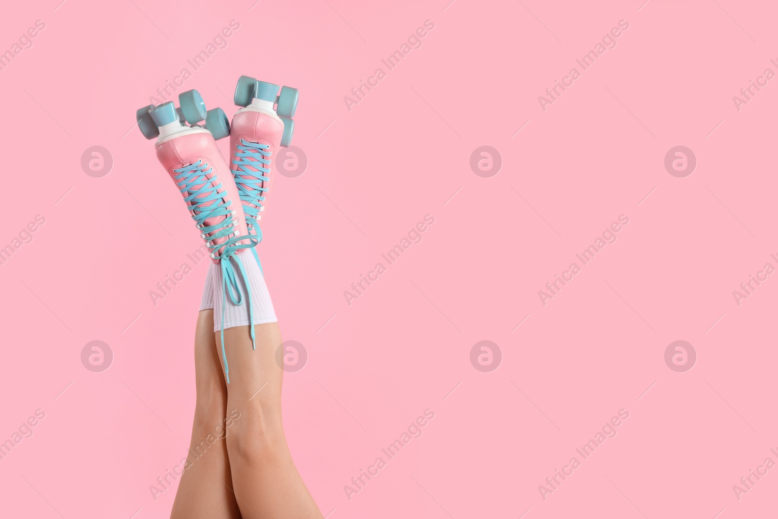 Woman in roller skates on pink background, closeup. Space for text Photo of Woman in roller skates on pink background, closeup. Space for text