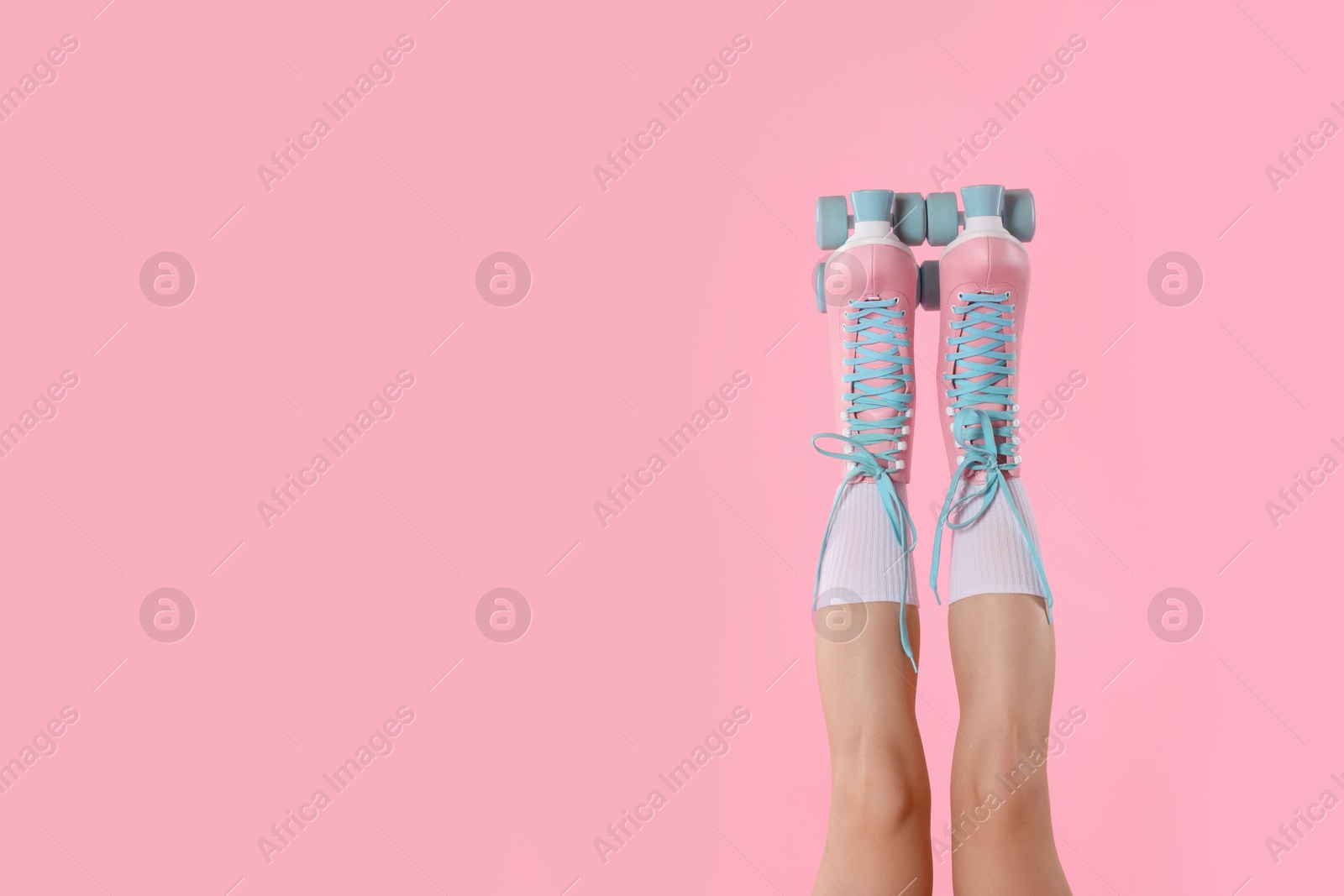 Woman in roller skates on pink background, closeup. Space for text Photo of Woman in roller skates on pink background, closeup. Space for text