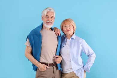 Photo of Lovely senior couple together on light blue background