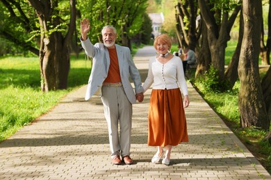 Photo of Lovely senior couple spending time together in park