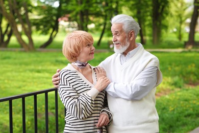 Photo of Lovely senior couple spending time together in park