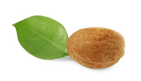 Photo of Whole nutmeg and leaf isolated on white