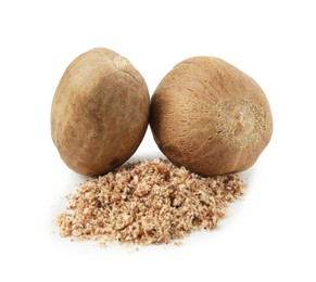 Photo of Whole nutmegs and powder isolated on white