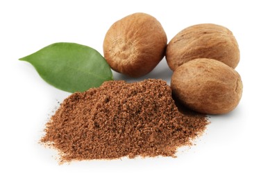 Photo of Whole nutmegs, powder and leaf isolated on white