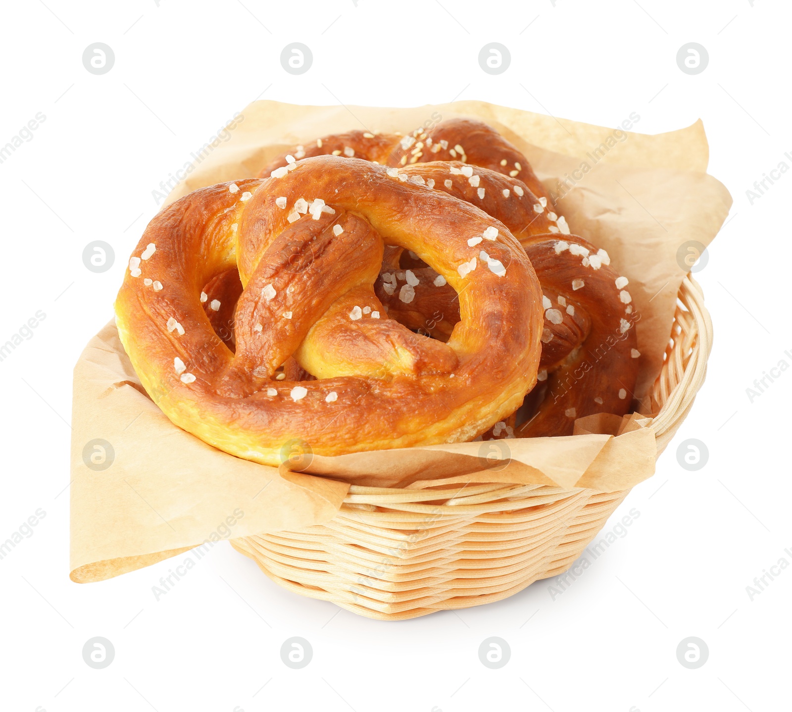 Tasty pretzels with salt in wicker basket isolated on white Photo of Tasty pretzels with salt in wicker basket isolated on white