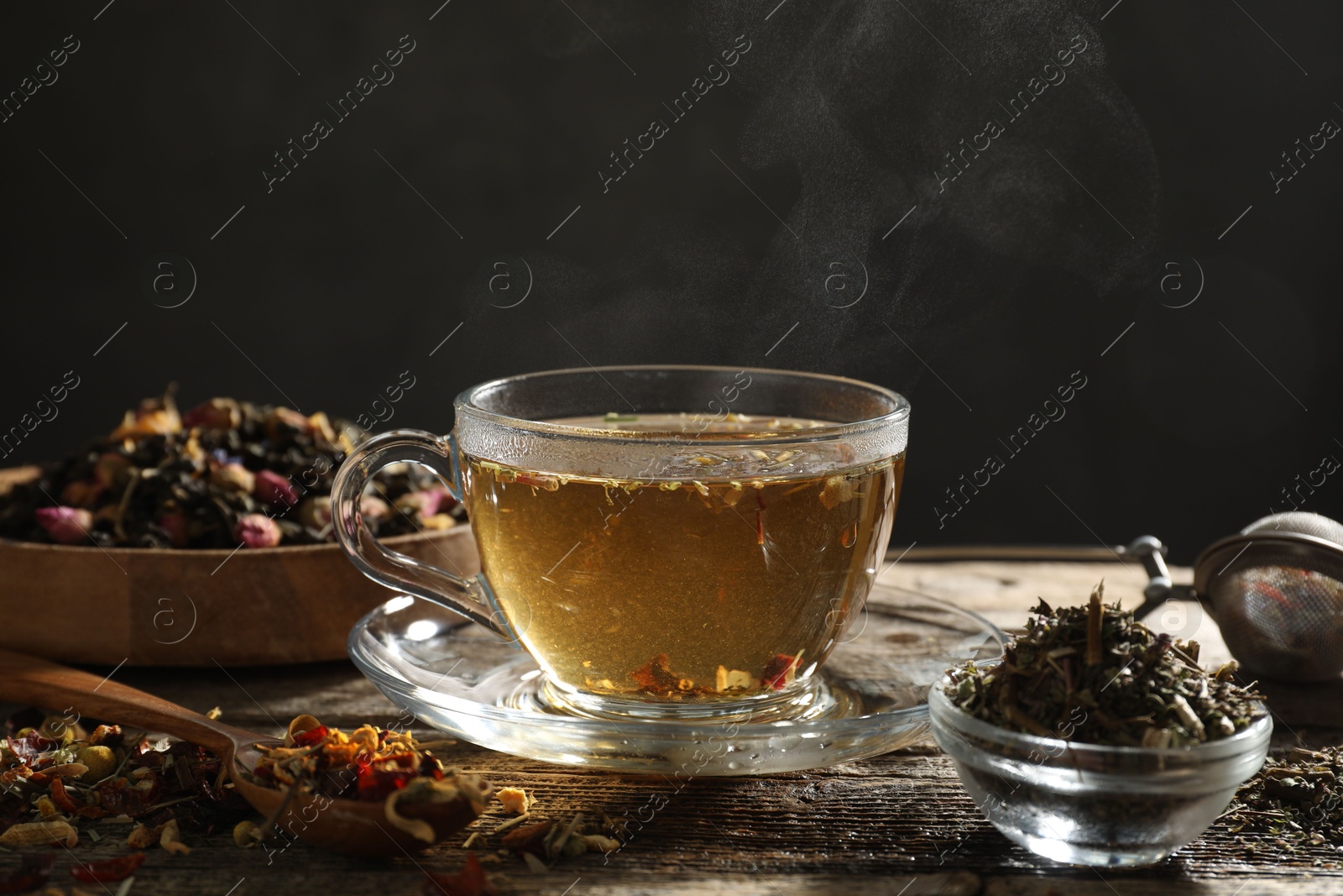 Refreshing herbal tea and dry leaves on wooden table, closeup. Space for text Photo of Refreshing herbal tea and dry leaves on wooden table, closeup. Space for text