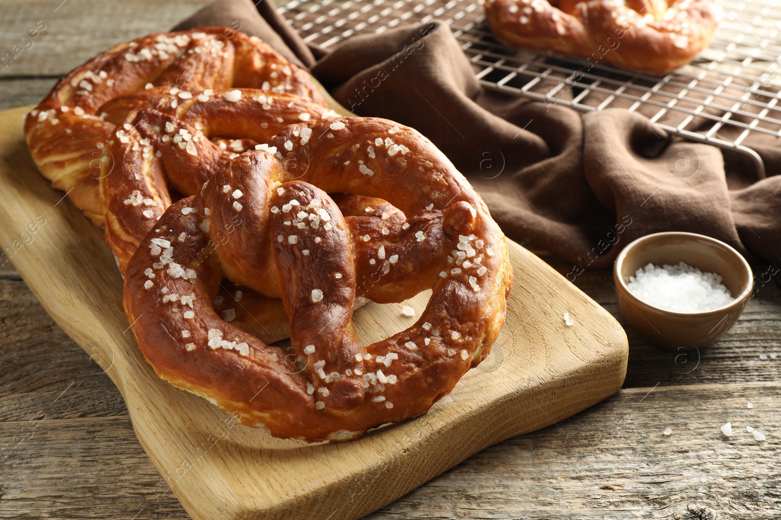 Tasty pretzels with salt on wooden table, closeup Photo of Tasty pretzels with salt on wooden table, closeup