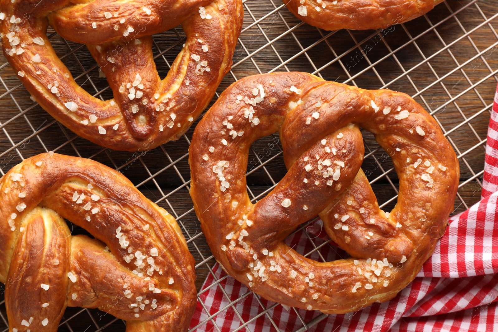 Tasty pretzels with salt on wooden table, top view Photo of Tasty pretzels with salt on wooden table, top view